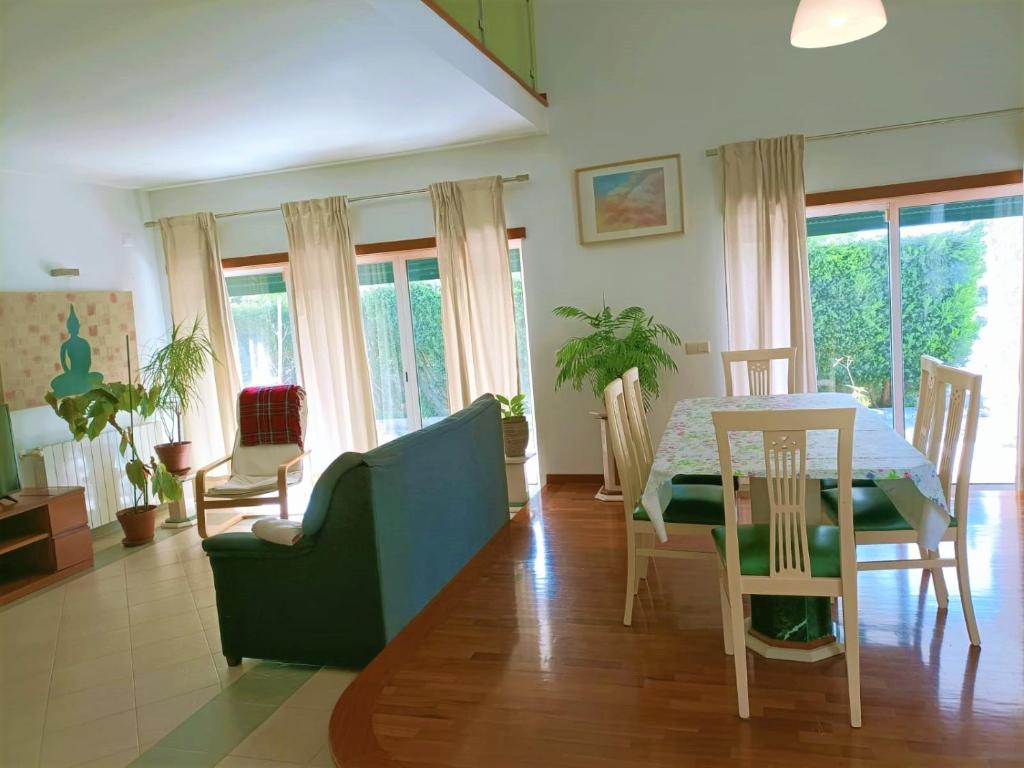 a living room with a table and a dining room at SINTRA HOME in Sintra