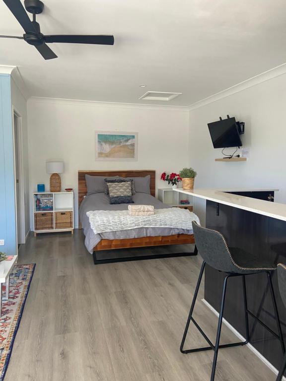 1 dormitorio con 1 cama y TV de pantalla plana en Scenic Sunsets@Tamborine en Tamborine