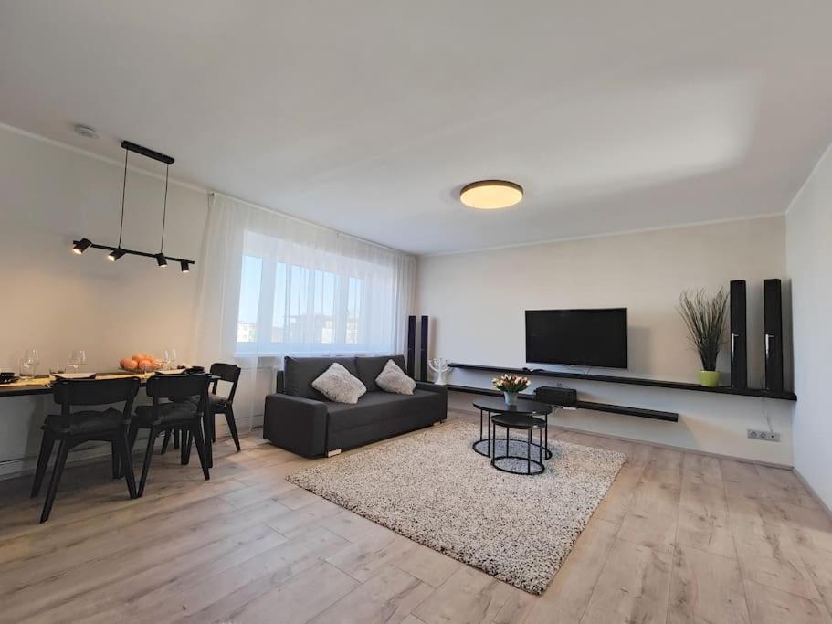 a living room with a couch and a dining room table at Lai Apartment in City center of Rakvere in Rakvere