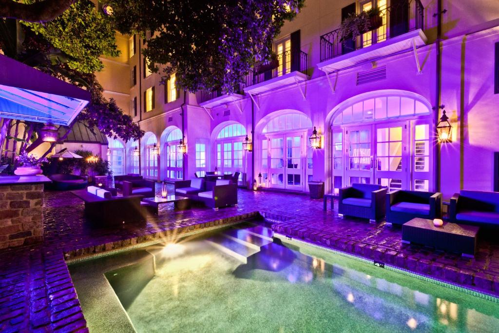 a house with a swimming pool in front of a building at Hotel Le Marais in New Orleans