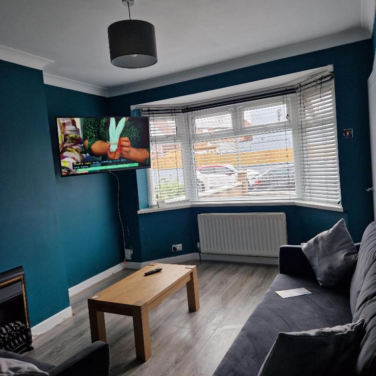 a living room with a couch and a table at Belfast City house in Belfast