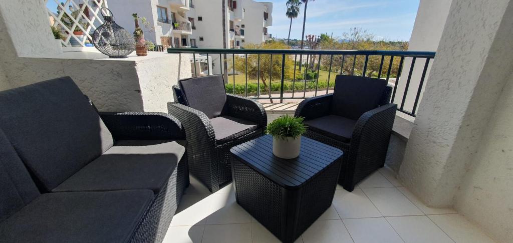 a patio with chairs and a table on a balcony at Apartment AlcudiaMar in Alcudia