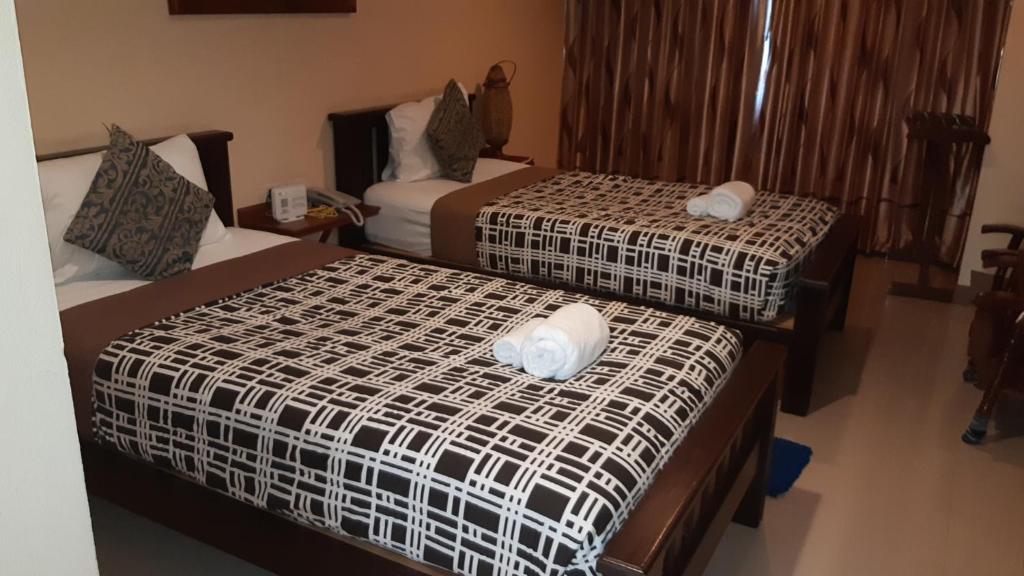 Postel nebo postele na pokoji v ubytování Baanmalai Hotel Chiangrai