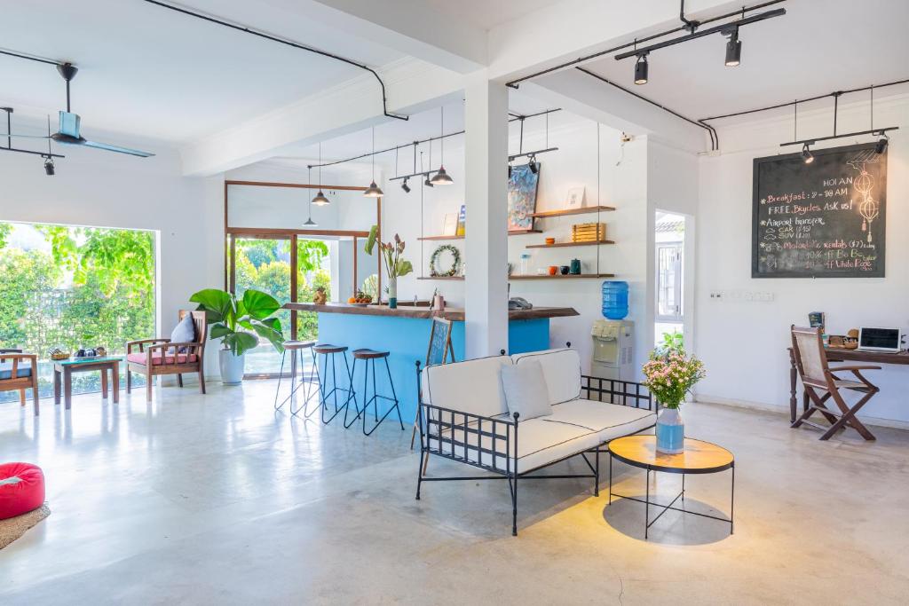 a living room with a couch and a table at Tra Que Mansion in Hoi An
