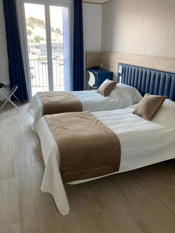 Postel nebo postele na pokoji v ubytování Hotel Le Golfe