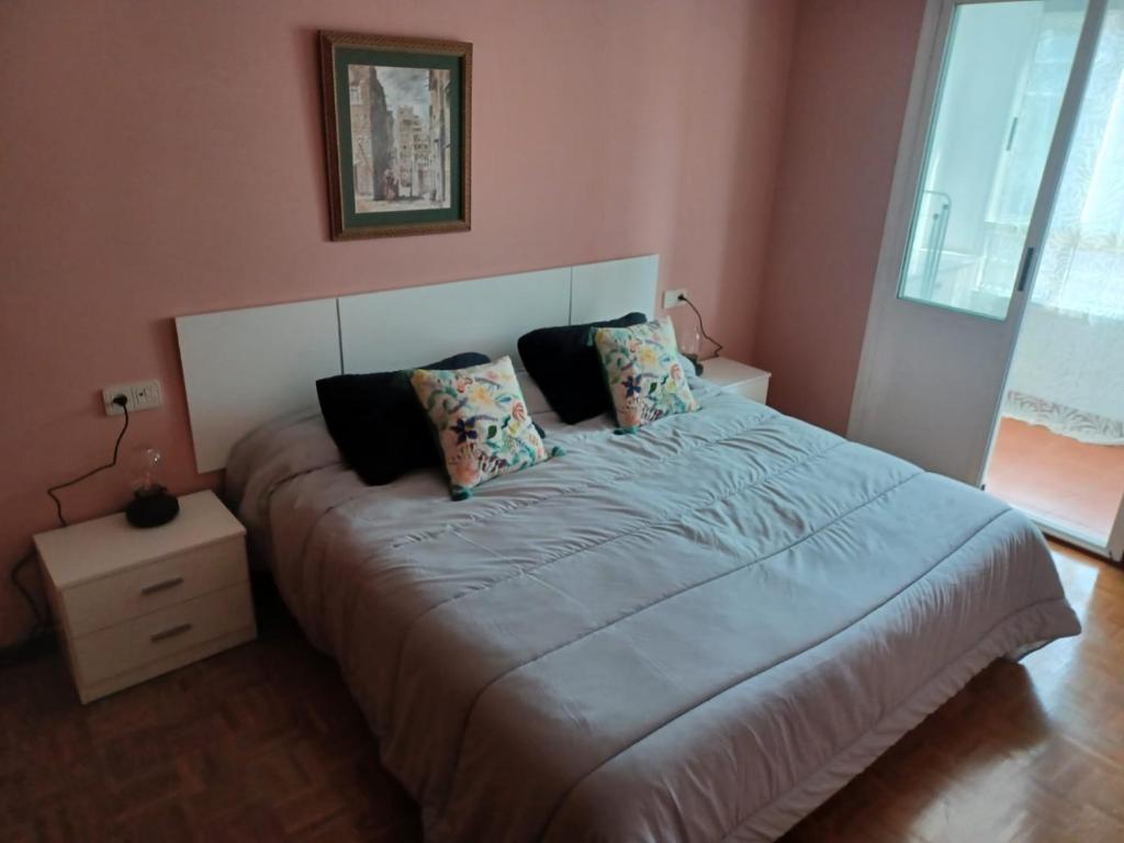 a bedroom with a large bed with two pillows at Xuan Inn - Garaje incluido in Avilés