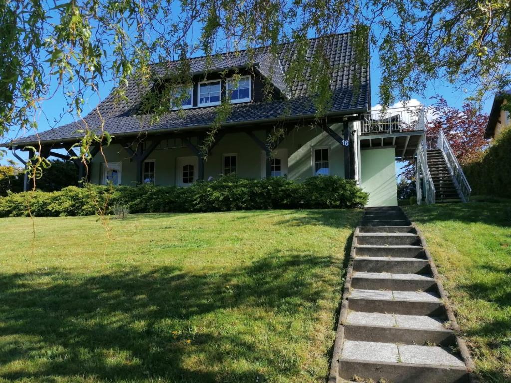 a house with stairs leading to the front yard at FeWo 3 im Haus Lohme OT Hagen in Hagen