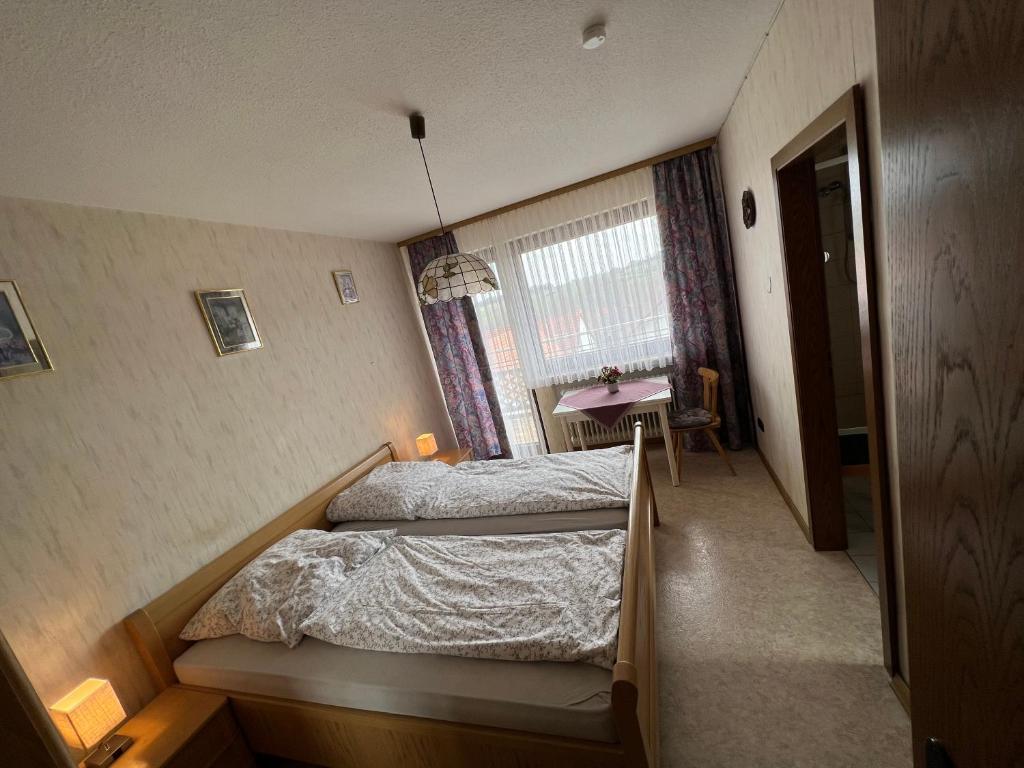 sypialnia z 2 łóżkami i stołem w obiekcie Doppelzimmer Nr 5 w mieście Freiensteinau