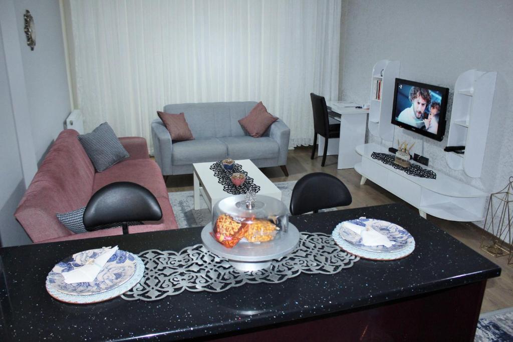 a living room with a table with plates of food on it at Roni in Esenyurt