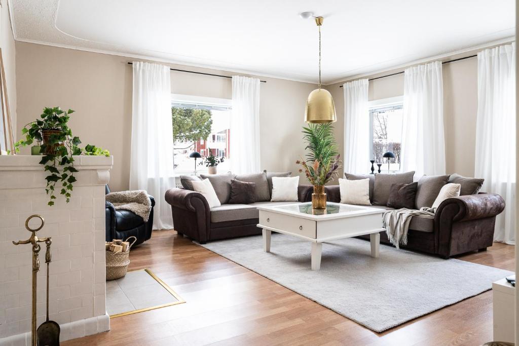 a living room with a couch and a coffee table at Munksund Apartments Villa in Piteå