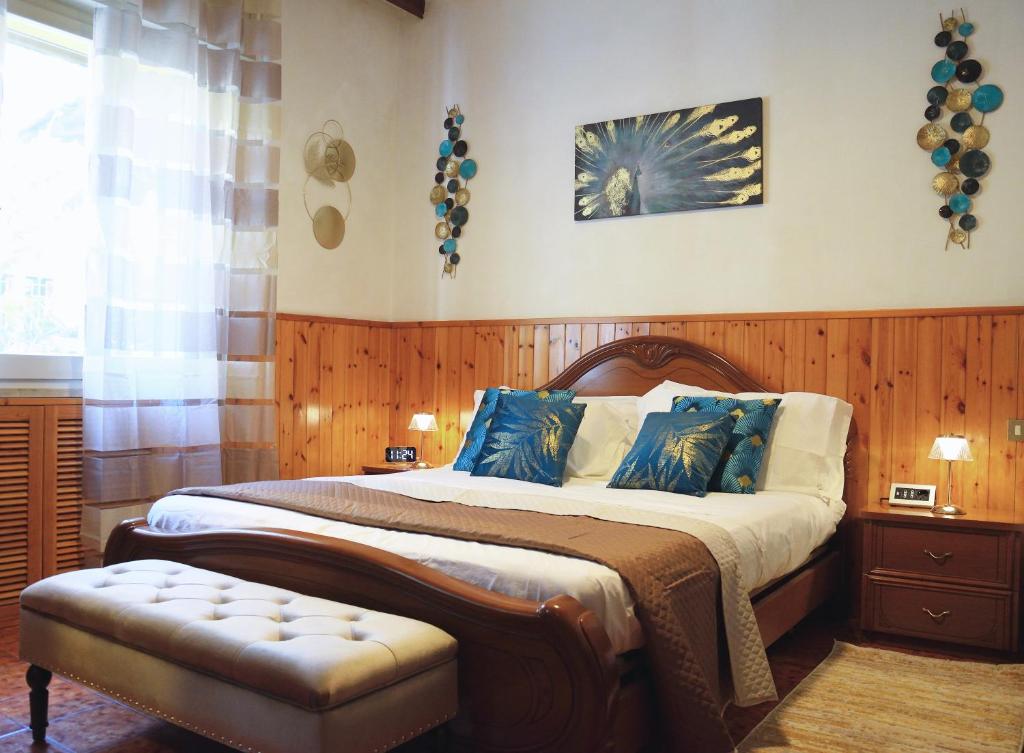 a bedroom with a large bed with blue pillows at Appartamento Diana Cervia in Cervia