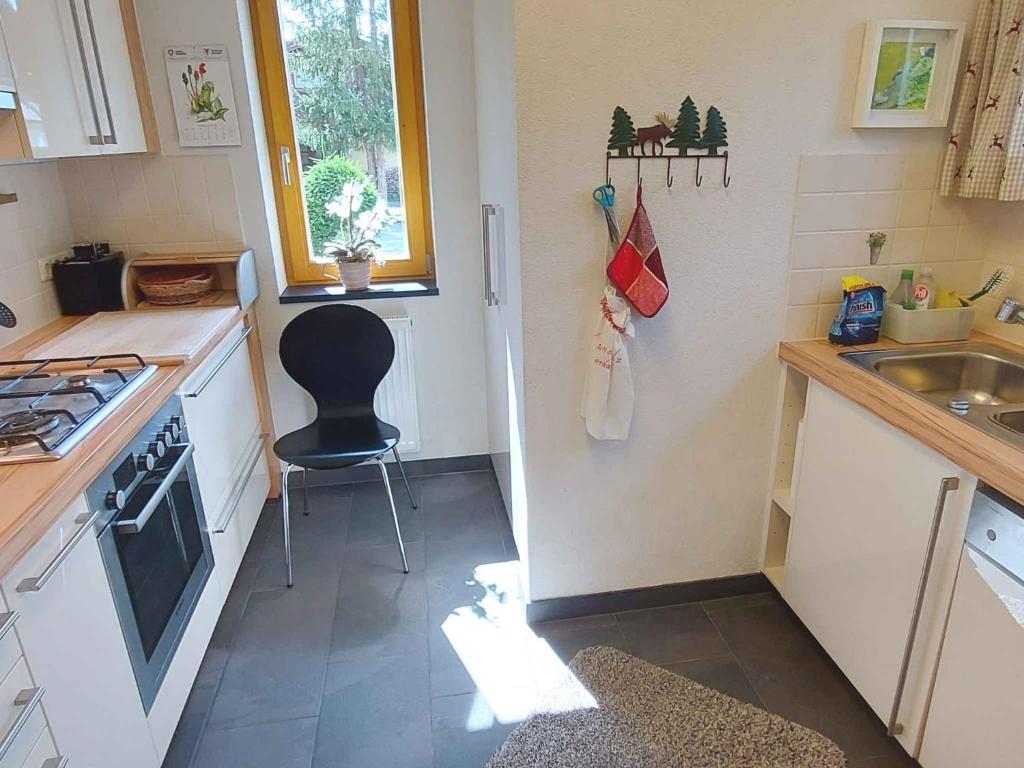 a small kitchen with a chair and a sink at Holiday home in Bad Mitterndorf - Steiermark 41114 in Bad Mitterndorf