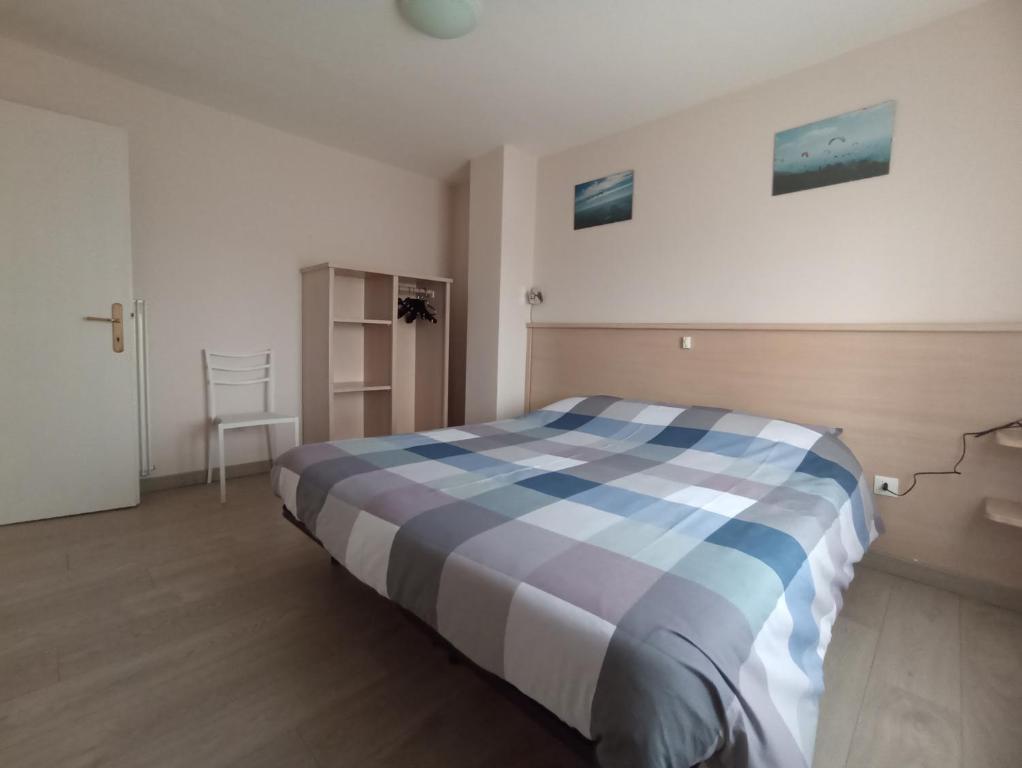 a bedroom with a bed with a blue and white at vololiberoapartments in Borso del Grappa