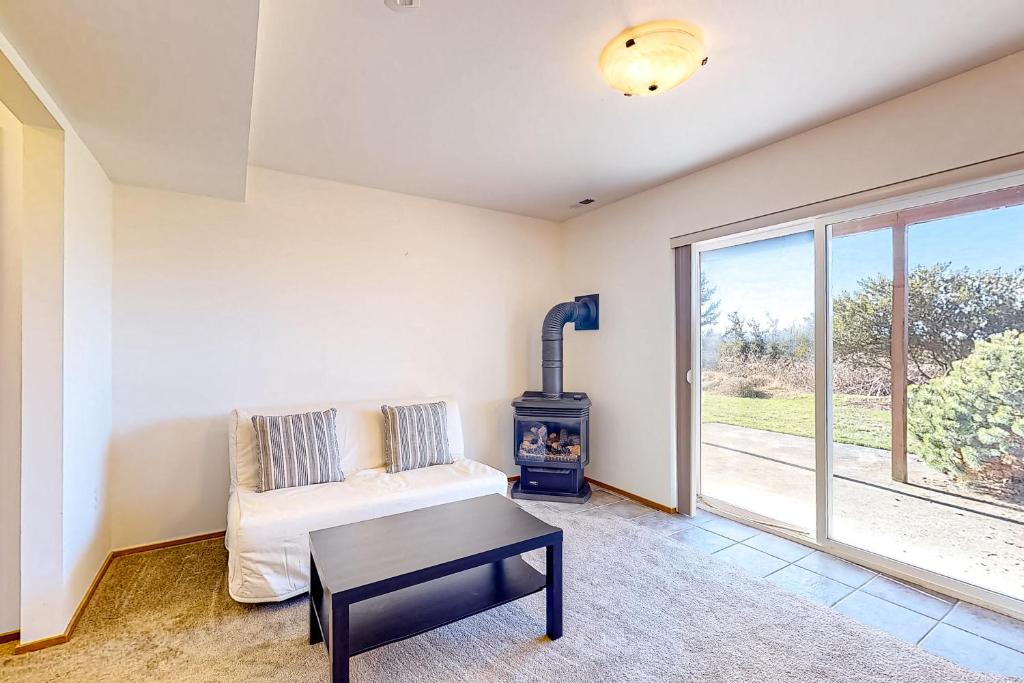 a living room with a couch and a stove at La Cana Street Leisure In Law Suite in Coupeville