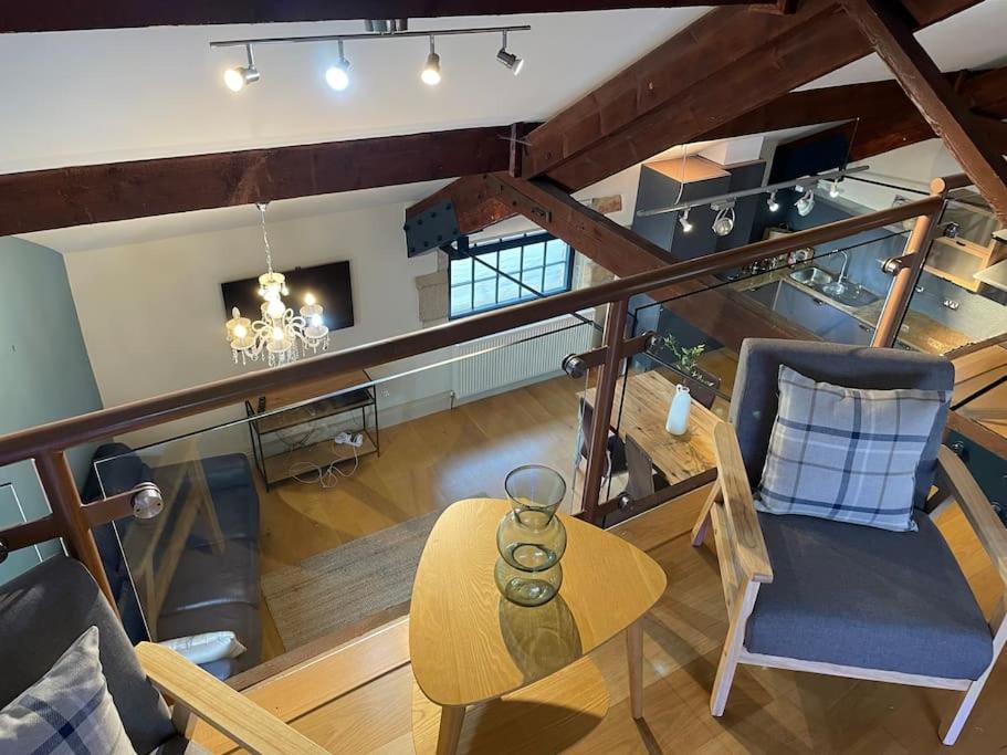 an overhead view of a living room with a table at Woodmill Bakewell Riverside in Bakewell