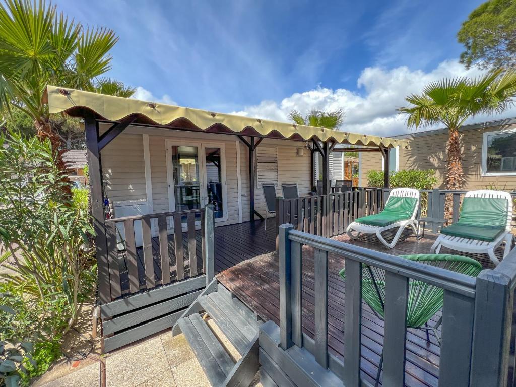 a deck with two chairs and a gazebo at Sas Robrecht in Saint-Tropez