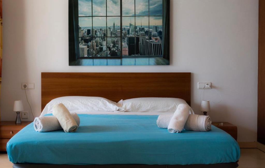 a large bed with two pillows on top of it at Amazing seafront apt in playa den bossa in Playa d'en Bossa