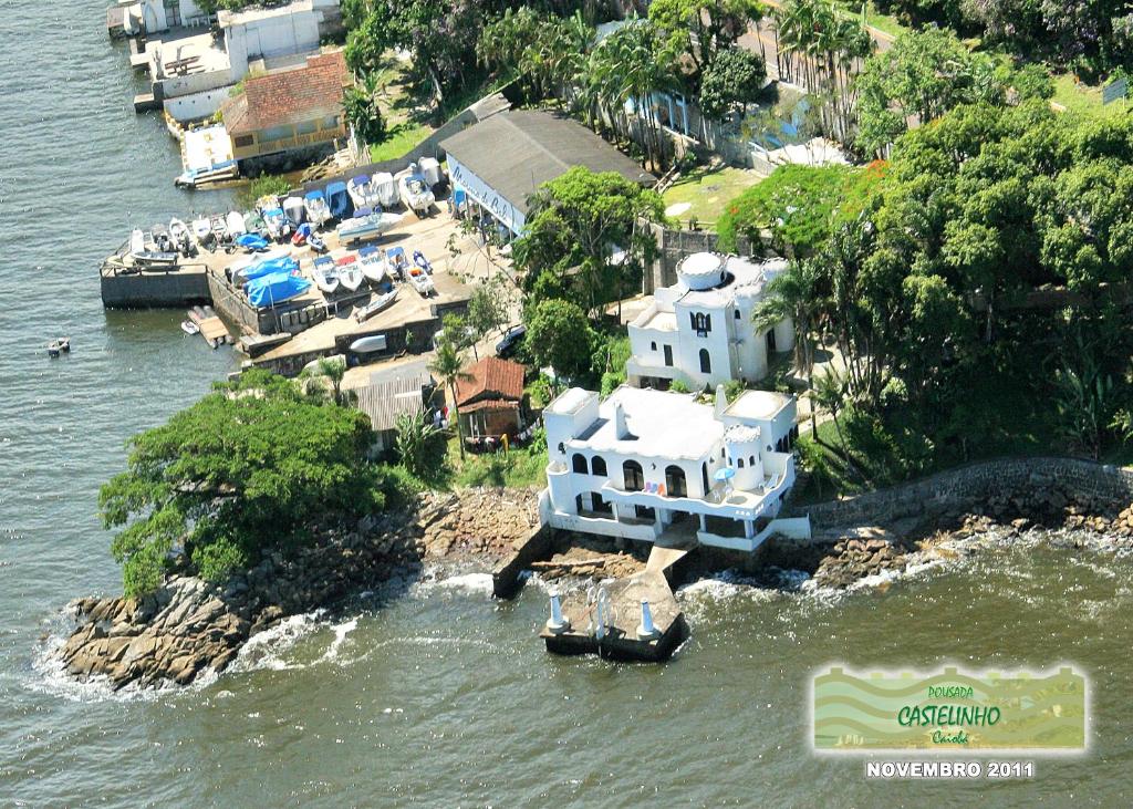 an aerial view of a house in the water at Pousada Castelinho Caiobá in Caiobá