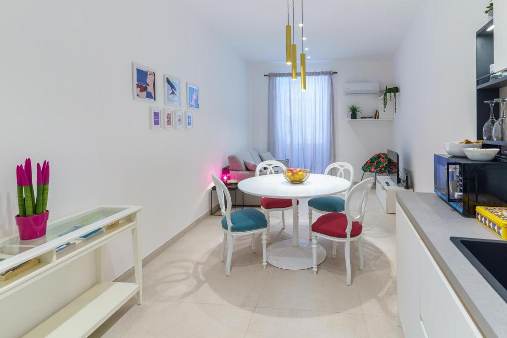 een keuken met een witte tafel en stoelen bij Casa Chicotta in Palermo