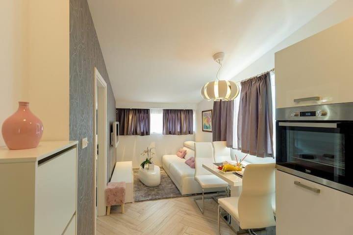 a living room with a white couch and a table at Stipe in Obuljeno