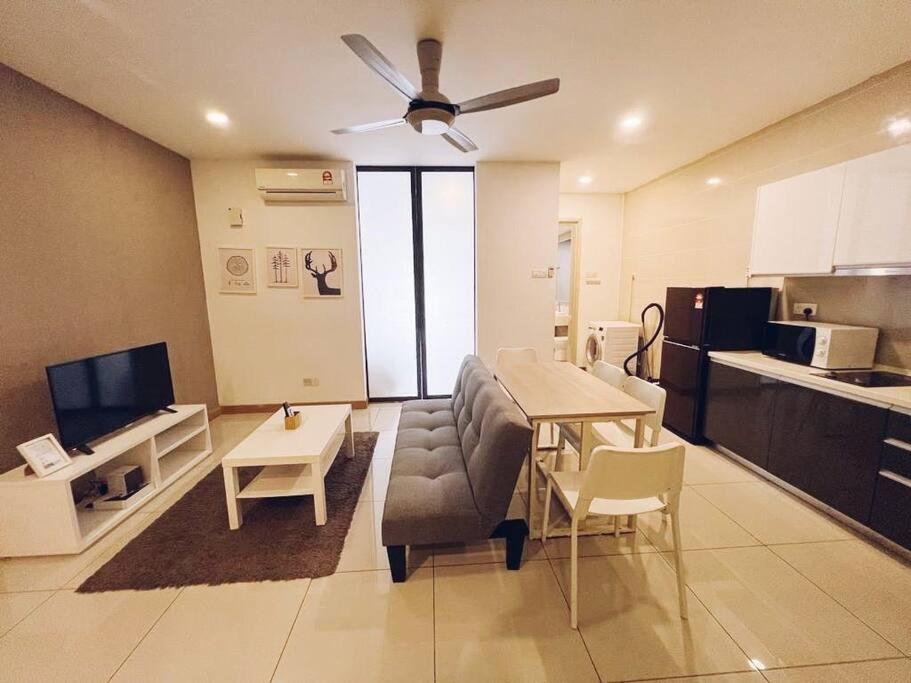 a living room with a dining table and a kitchen at PROMO Connected Train 2 Bedroom ABOVE MALL 289 in Kuala Lumpur