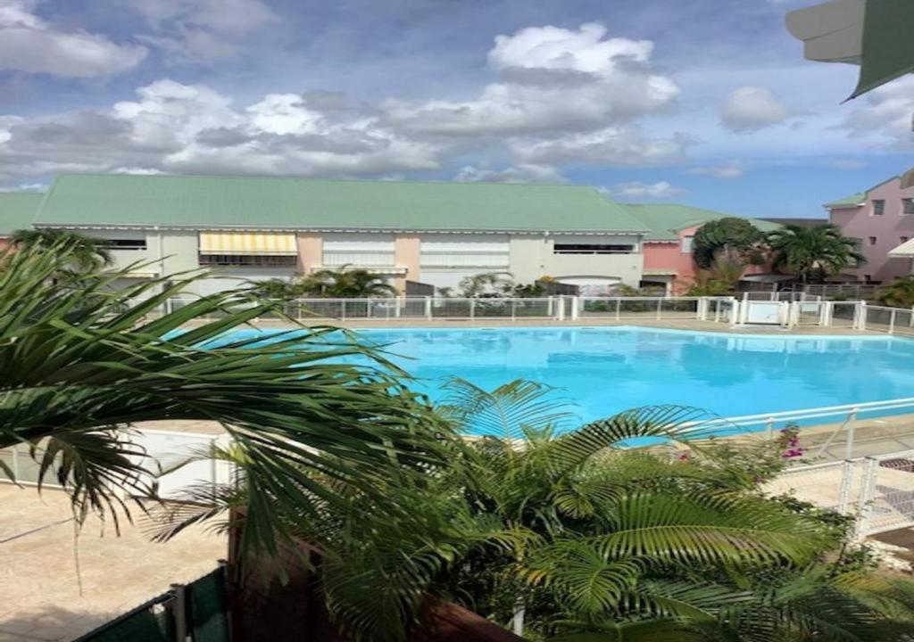 a large swimming pool in front of a building at Maison Agréable Familiale in Saint-François
