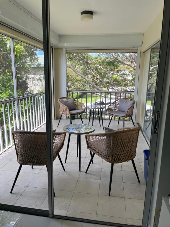 a patio with tables and chairs on a balcony at Great location with lake view in Naples