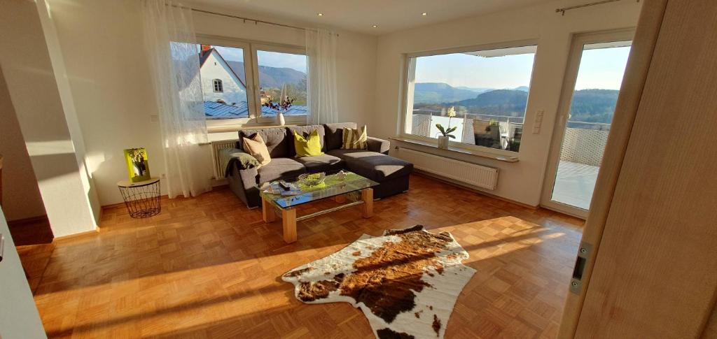 a living room with a couch and a large window at Marie´s Sonnenterrasse 