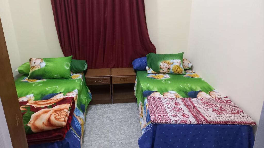 two beds in a small room at Ikea flat 4 in Hurghada