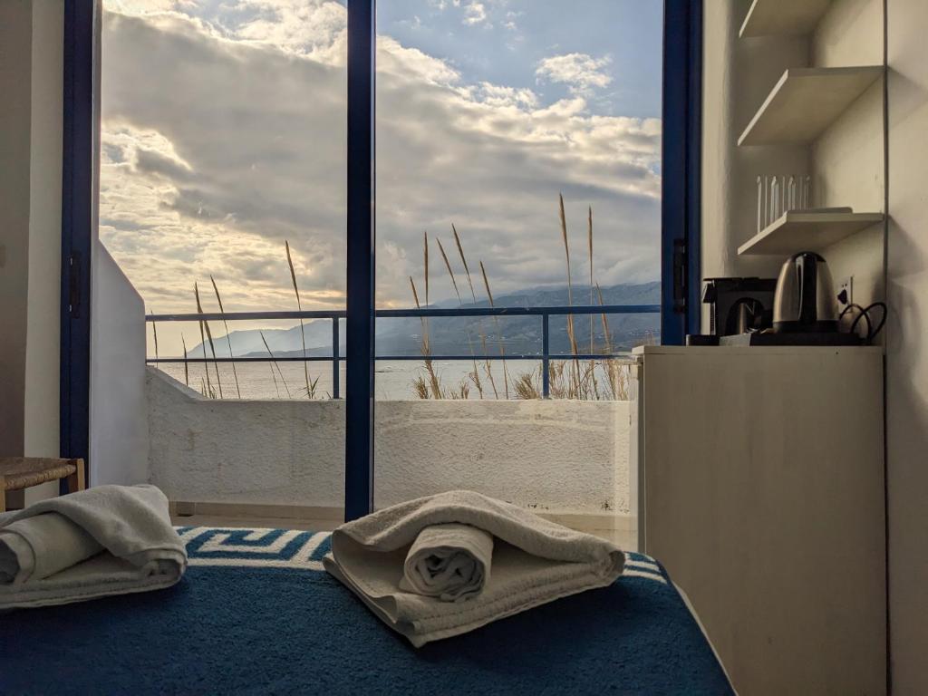 a room with a large window with towels on the floor at Coral in Frangokastello