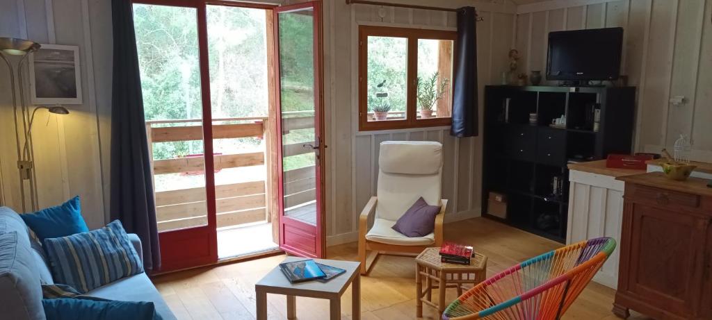 a living room with a couch and a chair at La cabane du Truquet in Lège-Cap-Ferret