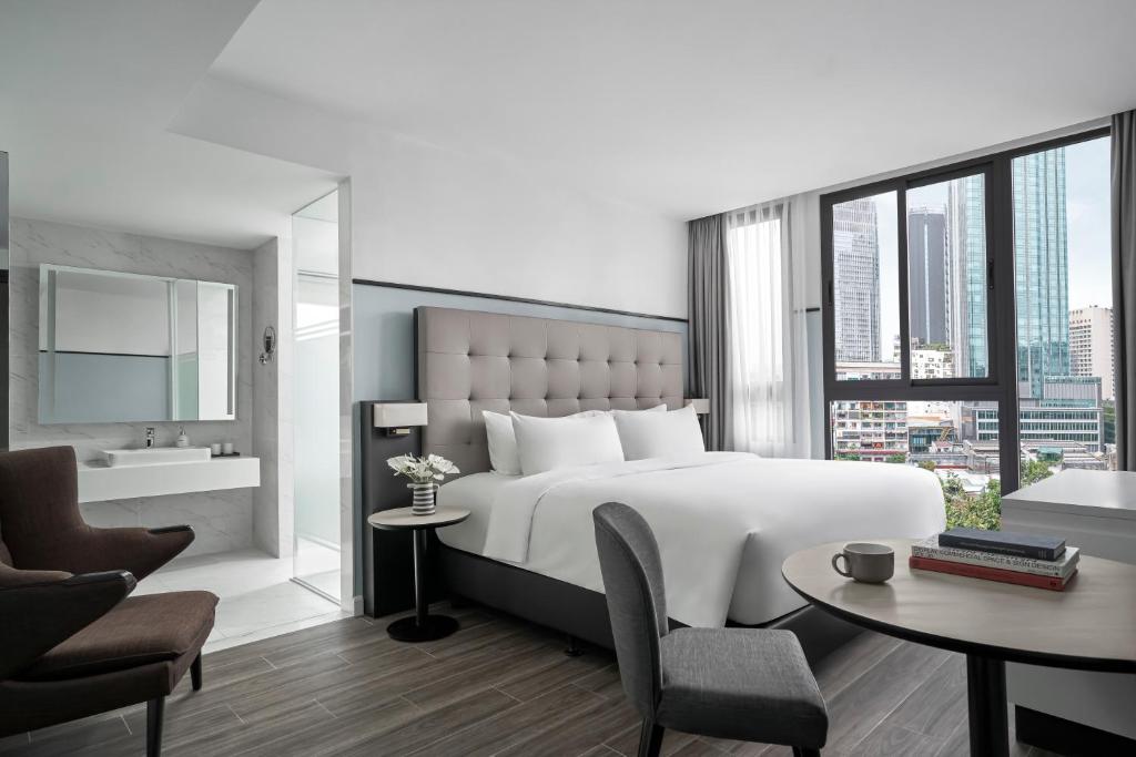 Cama o camas de una habitación en M Village Hotel Tôn Thất Đạm