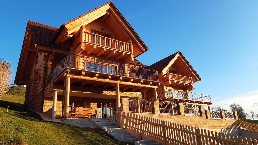 a large wooden house with steps in front of it at Biochalet Haus 1 in Gleinstätten