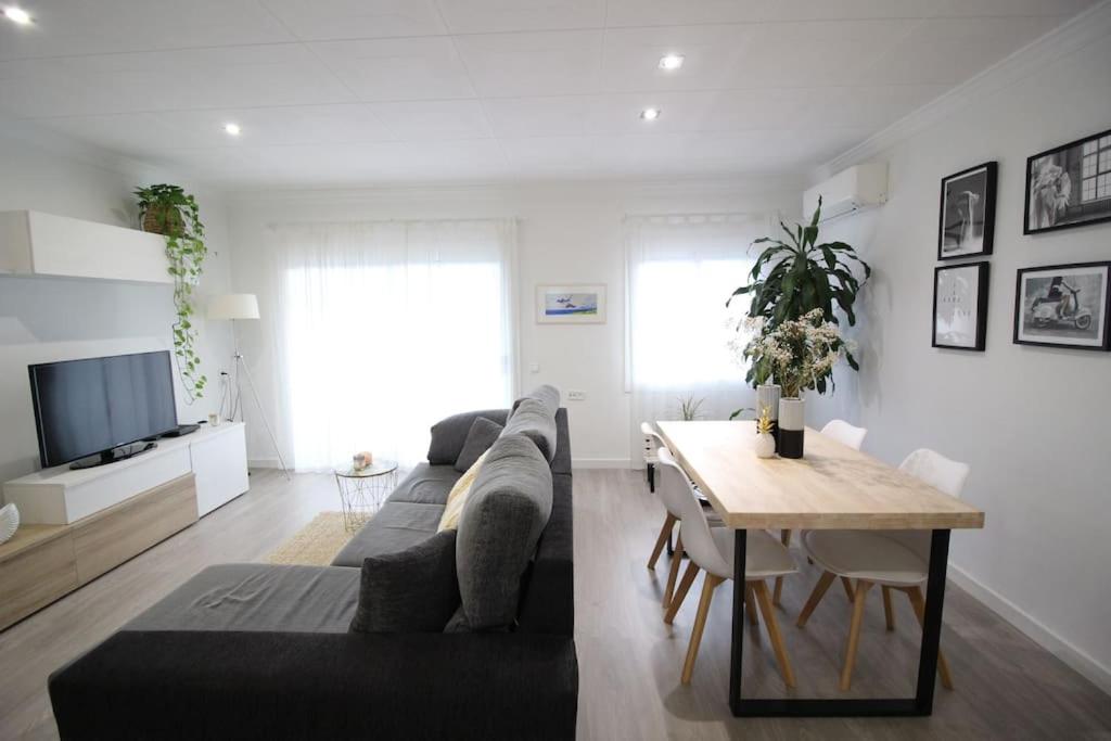 a living room with a couch and a table at Nice new apartment only 30min to Barcelona center. in Granollers