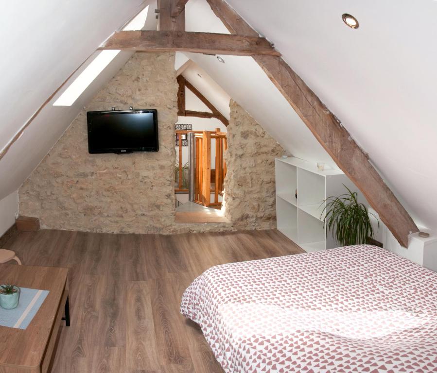 Säng eller sängar i ett rum på Logement cosy à proximité de Bayeux