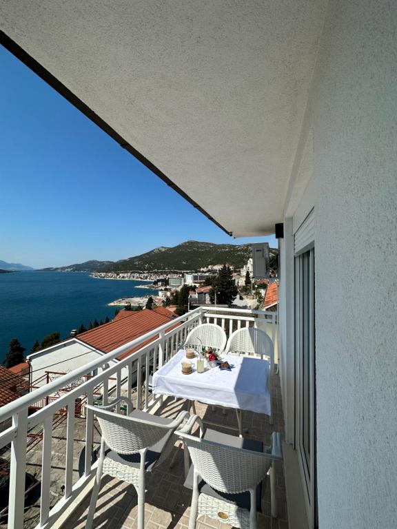 a balcony with a table and chairs and the ocean at Villa Senka in Neum