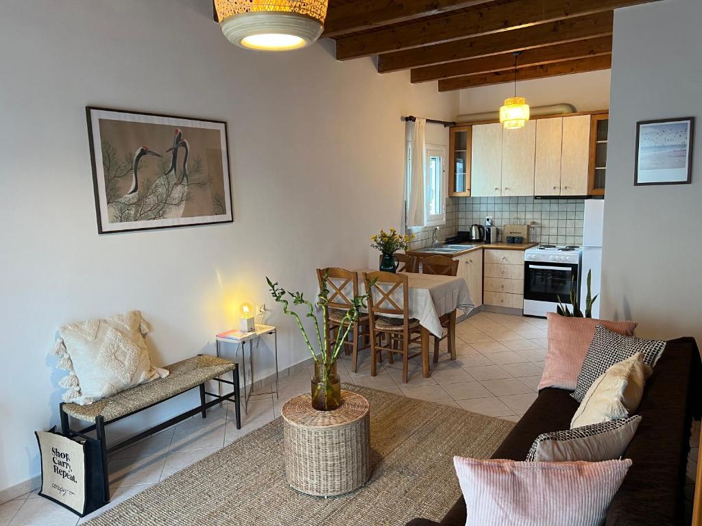 a living room with a couch and a table at Perdika's Nest, family friendly house by the sea in Perdika