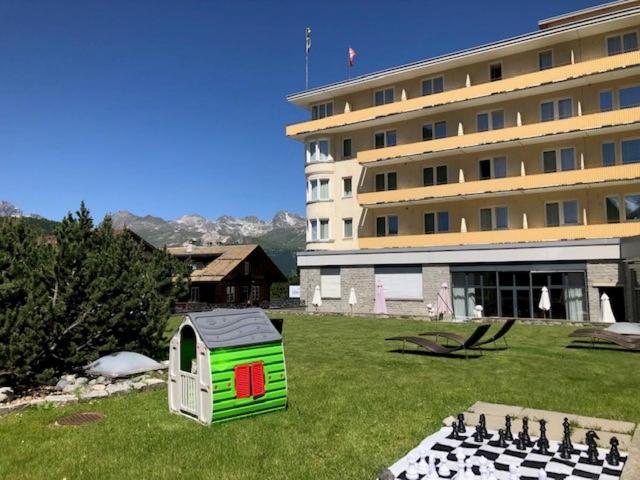 a building with a play set in front of a building at Hotel Schweizerhof Pontresina in Pontresina