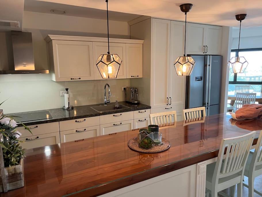 a kitchen with a large wooden counter top in a kitchen at Jaffas Yard By IsrApart in Tel Aviv