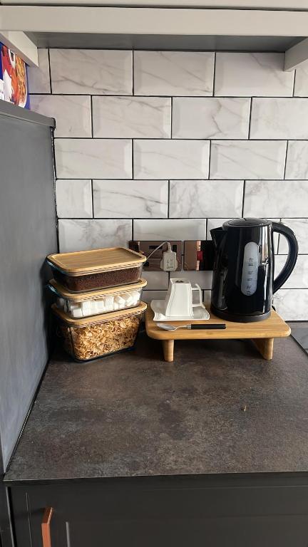 a kitchen counter with a coffee maker on a table at Single Room, Shared House in Bristol