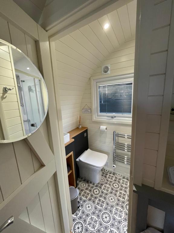 a small bathroom with a toilet and a sink at Abbey farm luxury glamping in Rhuddlan