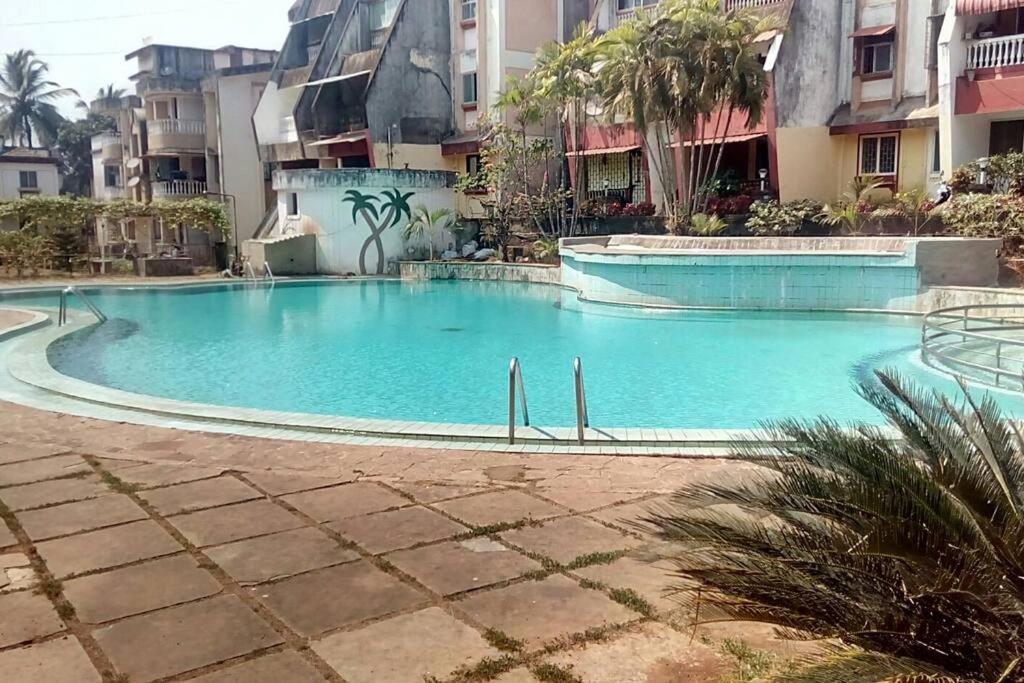 a large swimming pool in the middle of a building at Stay at Colva Beach in Colva