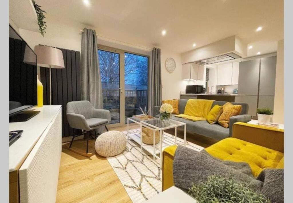 a living room with a couch and a table at 3 York Mews in Bath