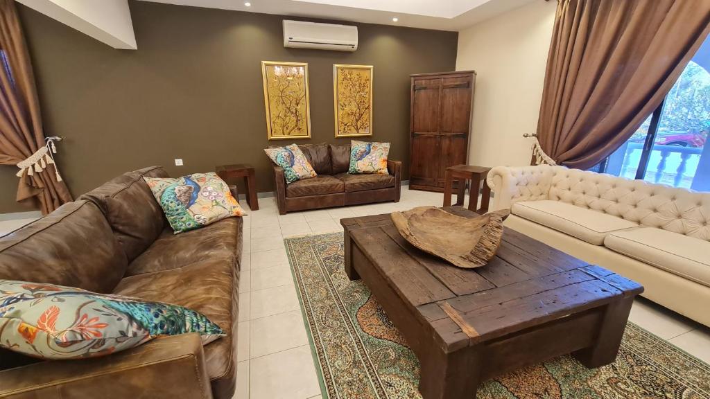 a living room with a couch and a coffee table at Unique Furnished Holiday Villa Bahrain 
