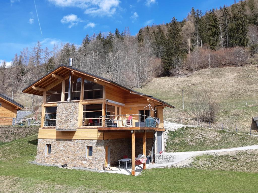 a house being built on a hill with trees at Anniviers : studio avec mezzanine in Vissoie