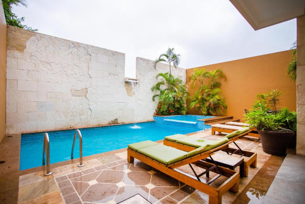 a swimming pool in a house with a pool at BLAZE Hotel & Suites Puerto Vallarta in Puerto Vallarta