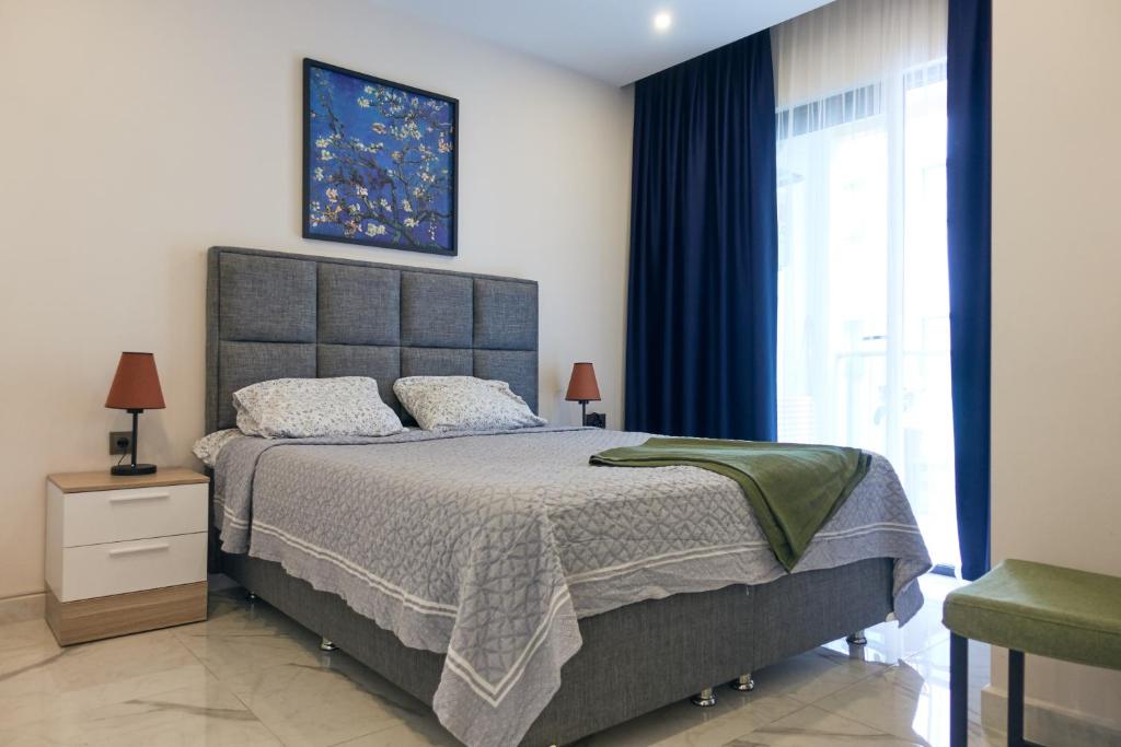a bedroom with a large bed and a window at Alanya City Tower sea&mountain view in Alanya