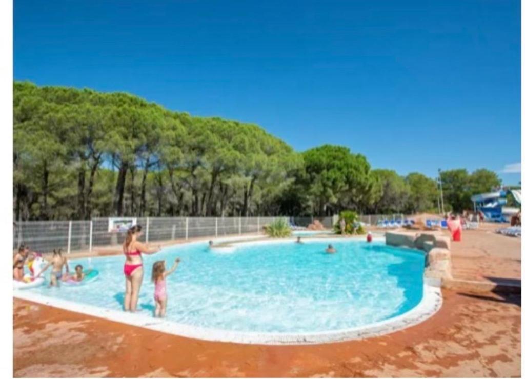 a group of people in a swimming pool at Camping Oasis village in Puget-sur-Argens