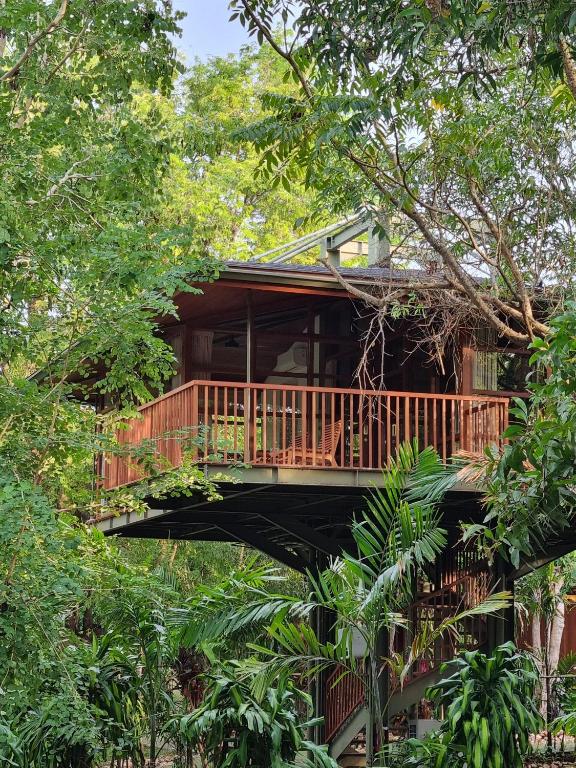 a tree house with a deck in the trees at Grün Resort Uluwatu in Uluwatu