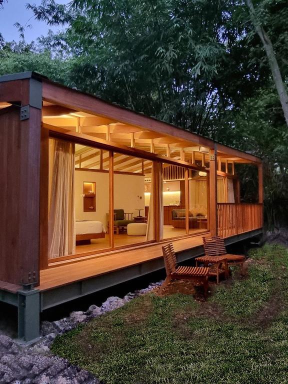 a small house with large glass windows and a couch at Grün Resort Uluwatu in Uluwatu